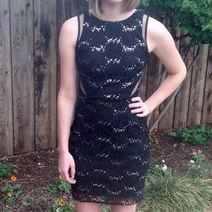 Black knee-length cocktail dress. Sequins & lacy embellishments, mesh cutouts